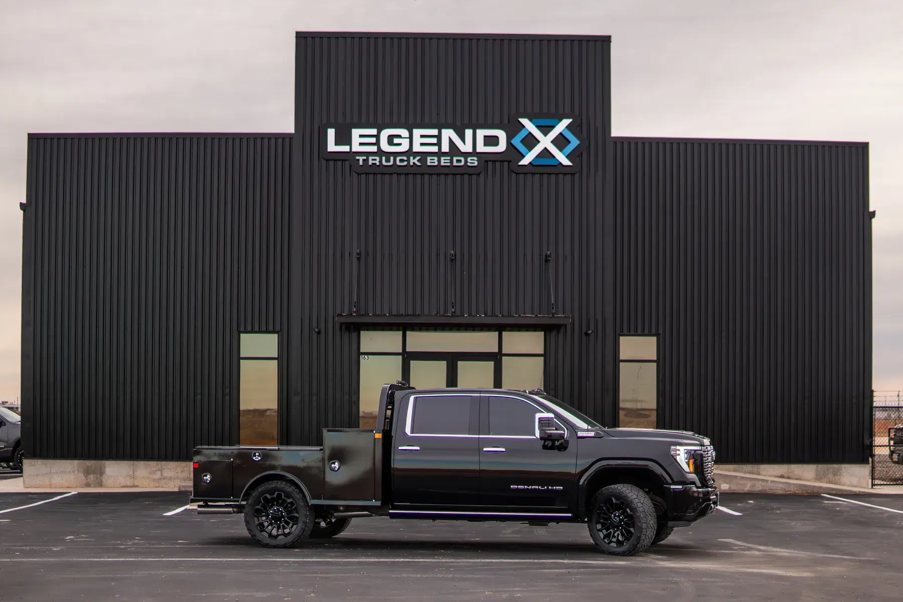 GMC Sierra Denali with an Apollo bed parked on the Legend X lot